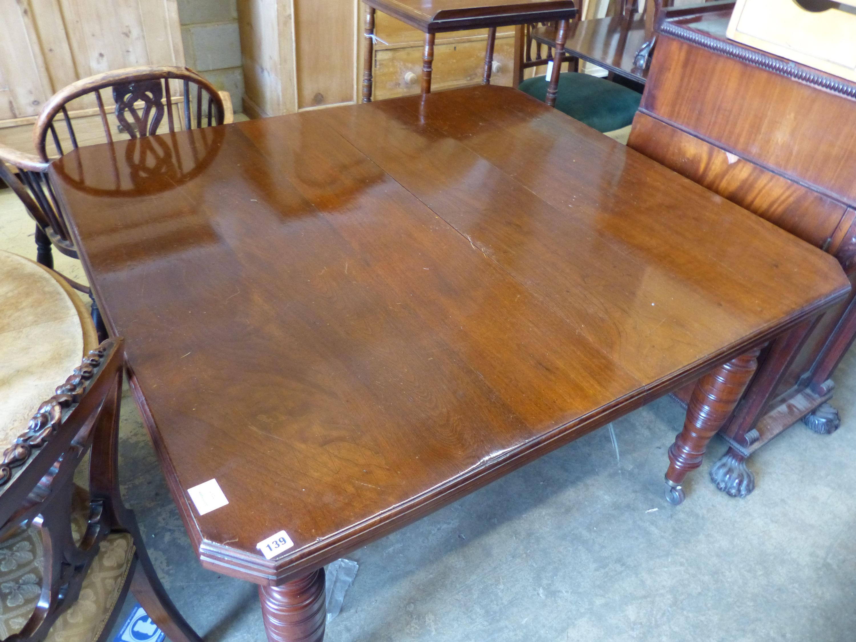 A late Victorian walnut extending dining table, (two spare leaves) 174cm extended, width 114cm, height 73cm.